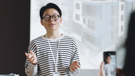 Asian-Woman-Speaking-to-Audience-on-Architecture-Conference